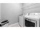 Neat laundry room featuring modern, white appliances, and wire rack shelving for organization at 12052 Northface Dr, Noblesville, IN 46060