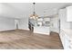 Spacious living room with fireplace, hardwood floors and view of stairs and kitchen at 12052 Northface Dr, Noblesville, IN 46060