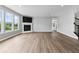 Living room features fireplace, large windows, hardwood floors and staircase at 12052 Northface Dr, Noblesville, IN 46060