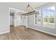 Spacious living room featuring wood-look floors, modern lighting, and lots of natural light at 12052 Northface Dr, Noblesville, IN 46060