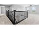 Upper level landing area features wrought iron railing, carpet, ceiling fan, and lots of natural light at 12052 Northface Dr, Noblesville, IN 46060