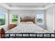 Bright main bedroom featuring neutral carpet, a bed with decorative headboard, and large windows at 12052 Northface Dr, Noblesville, IN 46060