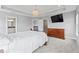 Spacious main bedroom features a TV, large windows, en-suite bath, and stylish furniture at 12052 Northface Dr, Noblesville, IN 46060