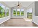 Light filled sunroom with vaulted ceilings, large windows and sliding glass door at 12052 Northface Dr, Noblesville, IN 46060