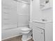 Bathroom featuring a shower, toilet, sink, and white cabinets at 1225 S Monroe St, Muncie, IN 47302