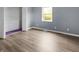 Bedroom with hardwood style floors and a closet, bathed in soft, natural light at 1225 S Monroe St, Muncie, IN 47302
