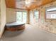 Hot tub room featuring wood paneled walls and ceiling with sliding doors to the yard at 1225 S Monroe St, Muncie, IN 47302
