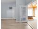Living room with hardwood-style floors leading to room with sliding doors and a hot tub at 1225 S Monroe St, Muncie, IN 47302