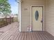 Close up of the front porch with a wood floor, door with an oval window and security system at 1225 S Monroe St, Muncie, IN 47302