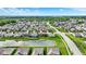 An aerial view showcasing the home's location within a vibrant community, complete with a serene pond and manicured landscapes at 1286 Brookdale Ct, Franklin, IN 46131