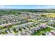 An aerial view of the neighborhood featuring lush green lawns, a tranquil pond, and community roads with mature trees at 1286 Brookdale Ct, Franklin, IN 46131