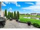 Backyard featuring a charming patio, fire pit, manicured lawn, and a pond, perfect for outdoor gatherings at 1286 Brookdale Ct, Franklin, IN 46131