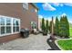 Backyard with a stamped concrete patio featuring a grill, seating, landscaping, and an exterior view of the home at 1286 Brookdale Ct, Franklin, IN 46131
