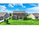 Spacious backyard featuring a well-maintained lawn, mature trees, patio, and exterior view of the home at 1286 Brookdale Ct, Franklin, IN 46131
