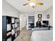 This light-filled bedroom includes a desk, shelving unit, comfortable bed, and neutral decor for a serene retreat at 1286 Brookdale Ct, Franklin, IN 46131