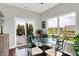 A cozy dining area featuring a glass table with views of the backyard pond and patio at 1286 Brookdale Ct, Franklin, IN 46131