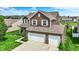 An exterior elevation showcasing a two-story home with a two-car garage, manicured lawn, and well-maintained landscaping at 1286 Brookdale Ct, Franklin, IN 46131