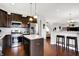 A well-appointed kitchen featuring stainless steel appliances, a center island, and dark wood cabinets at 1286 Brookdale Ct, Franklin, IN 46131