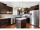 Modern kitchen with dark cabinets, stainless steel appliances, and a large island at 1286 Brookdale Ct, Franklin, IN 46131