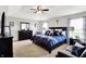 Spacious main bedroom featuring a tray ceiling, fan, and a luxurious king-size bed at 1286 Brookdale Ct, Franklin, IN 46131