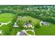 Acreage includes a racetrack, tennis court, horse facilities, mature trees, and multiple residences at 12945 E 100 N, Columbus, IN 47203