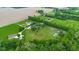 Aerial of expansive acreage featuring racetrack, tennis court, horse amenities and multiple homes at 12945 E 100 N, Columbus, IN 47203