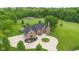 Aerial view of estate on acreage including tennis court, horse area, outdoor space and mature landscaping at 12945 E 100 N, Columbus, IN 47203