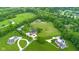 Spacious lot with racetrack and horse area, featuring lush lawns and mature landscaping at 12945 E 100 N, Columbus, IN 47203