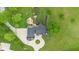 An aerial shot of the home highlighting the outdoor lounge space and lush surrounding landscaping at 12945 E 100 N, Columbus, IN 47203
