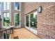 Inviting back porch with access to interior through glass doors and stylish outdoor lighting at 12945 E 100 N, Columbus, IN 47203