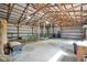 Spacious barn interior with open beams, offering versatile space for storage and hobbies at 12945 E 100 N, Columbus, IN 47203