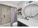 Modern bathroom with decorative mirror, custom shelves, and shower-tub combo at 12945 E 100 N, Columbus, IN 47203