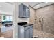 Bathroom featuring tile shower, built-in shelving, and vanity with cabinet storage at 12945 E 100 N, Columbus, IN 47203