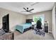 Comfortable bedroom features a ceiling fan, natural light, and ample space for a desk and storage at 12945 E 100 N, Columbus, IN 47203