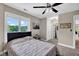 Well-lit bedroom with adjoining bathroom, closet space, and large window offering a view at 12945 E 100 N, Columbus, IN 47203