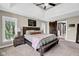 Bright bedroom featuring ceiling fan, tray ceiling, and natural light at 12945 E 100 N, Columbus, IN 47203