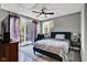 Bedroom featuring a ceiling fan and sliding glass doors to the exterior at 12945 E 100 N, Columbus, IN 47203