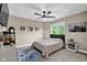 Inviting bedroom with neutral walls, carpeted floors, and a black ceiling fan at 12945 E 100 N, Columbus, IN 47203