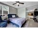 Bedroom featuring a ceiling fan, comfortable chair and natural light at 12945 E 100 N, Columbus, IN 47203