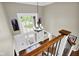 Open foyer with a grand chandelier, natural light and hardwood floors at 12945 E 100 N, Columbus, IN 47203