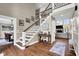 Elegant foyer with hardwood floors, staircase with wrought iron railing, and an open floor plan at 12945 E 100 N, Columbus, IN 47203