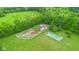Aerial view of horse area, including tennis court, shed, and grassy areas at 12945 E 100 N, Columbus, IN 47203