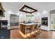 Modern kitchen with a large island, stainless steel appliances, and custom lighting at 12945 E 100 N, Columbus, IN 47203