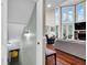 Bright living room featuring a fireplace, tall windows, and hardwood floors at 12945 E 100 N, Columbus, IN 47203