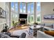 Bright living room featuring a fireplace and large windows offering views of the landscape at 12945 E 100 N, Columbus, IN 47203