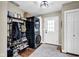 Practical mudroom area equipped with laundry machines, storage shelves, and convenient organization at 12945 E 100 N, Columbus, IN 47203