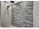 Walk-in shower with decorative stone accent wall at 12945 E 100 N, Columbus, IN 47203