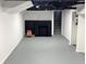 Finished basement with painted floor and fireplace at 1417 N Belleview Pl, Indianapolis, IN 46222