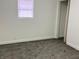 Cozy bedroom showcasing neutral carpet, fresh white walls, and natural light from the window at 1417 N Belleview Pl, Indianapolis, IN 46222