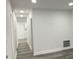 Hallway with modern gray floors, white walls, and recessed lighting at 1417 N Belleview Pl, Indianapolis, IN 46222